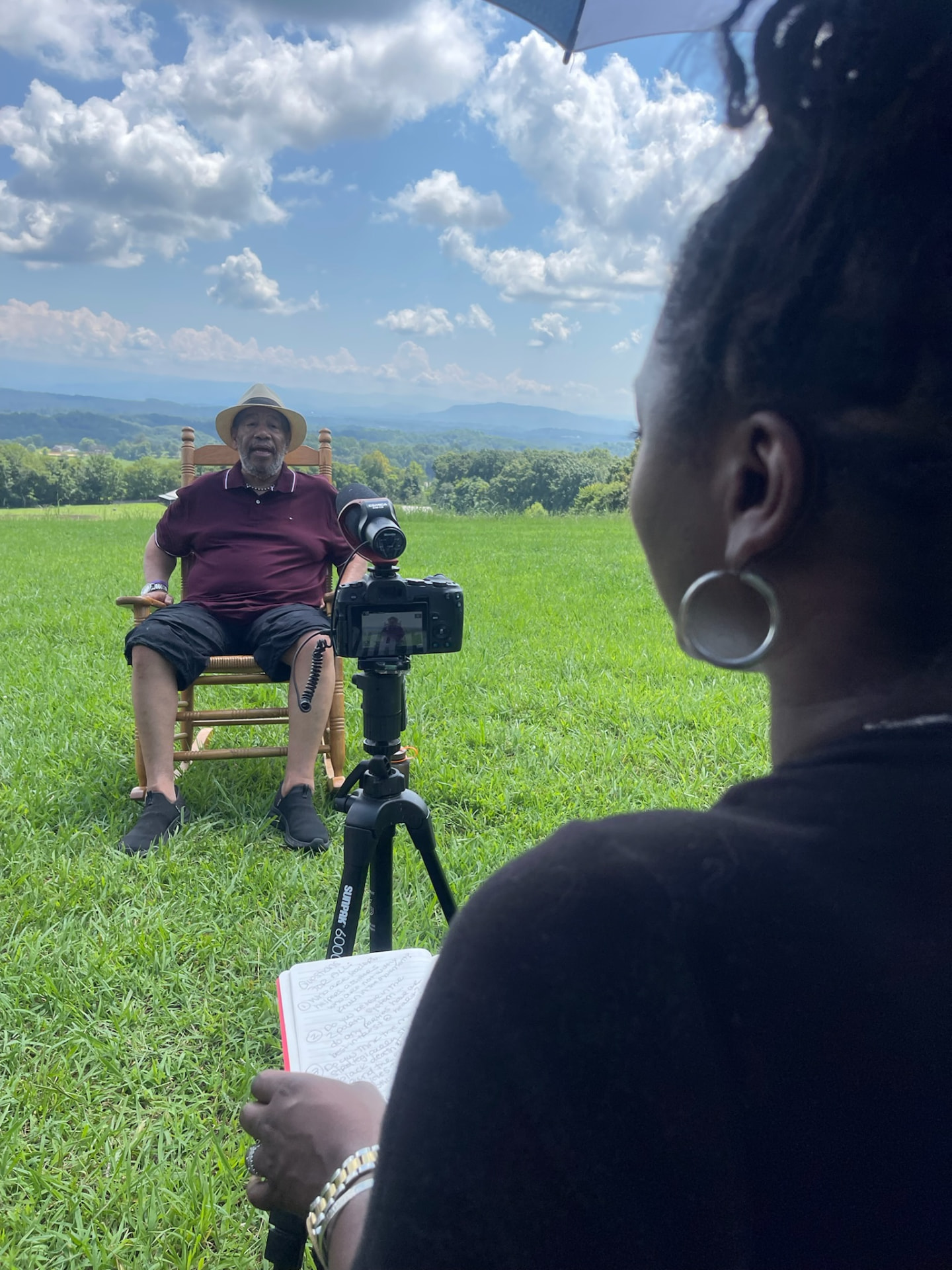 Jasmine Ballard interviewing civil-rights leader Michael Simmons outdoors at Highlander Research and Education Center.