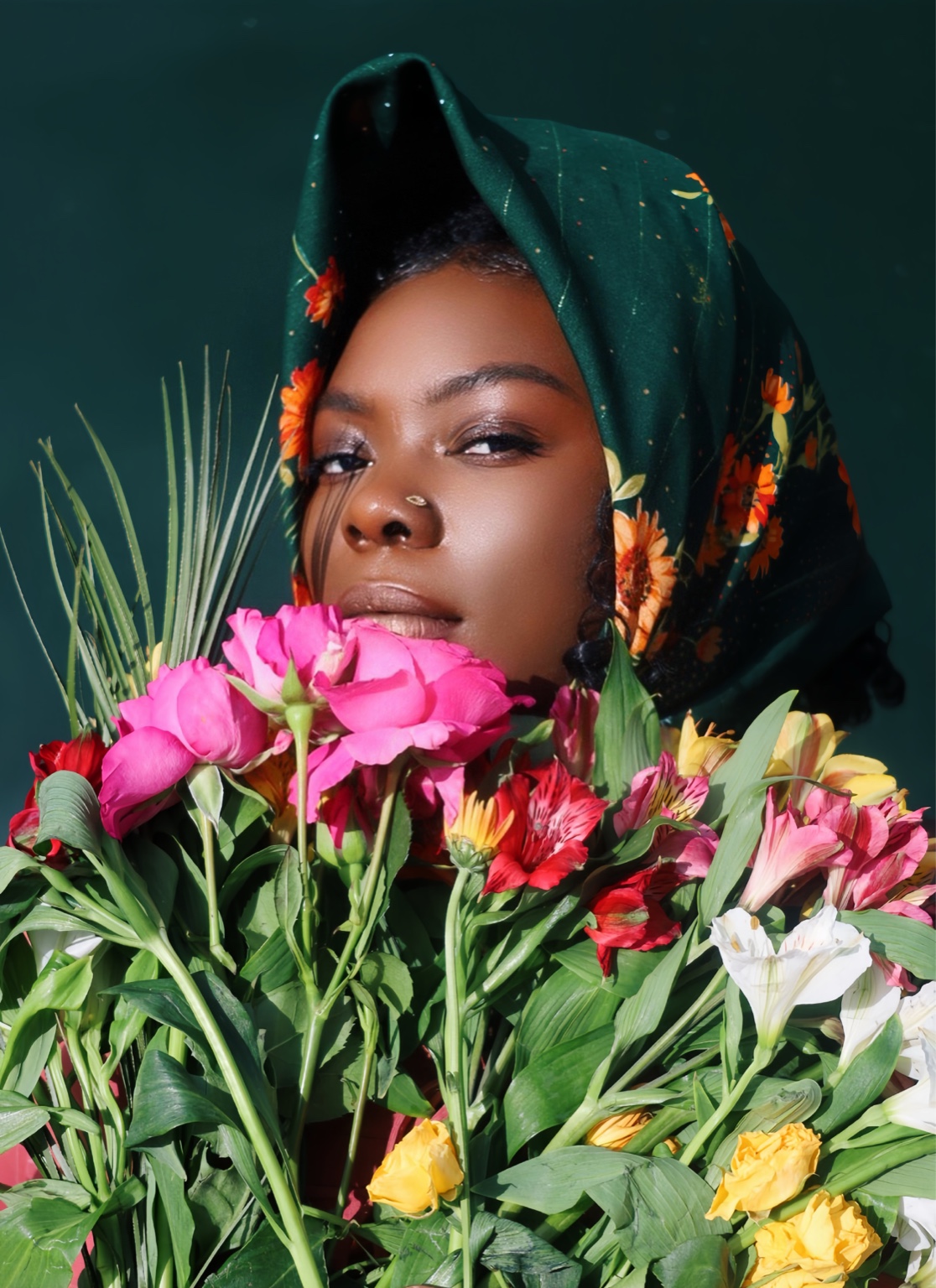 Jasmine Ballard photographed among vivid flowers for Fantastical Resistance.